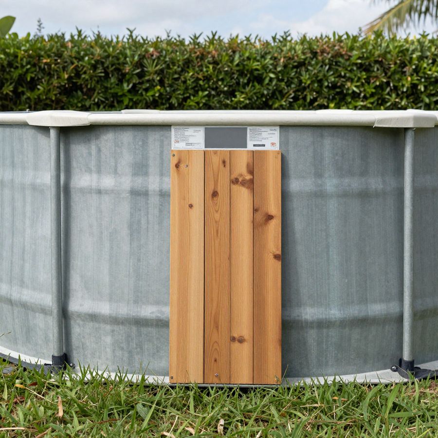 An above-ground pool wall seen from outside at ground level, the height that decides whether it counts as the barrier